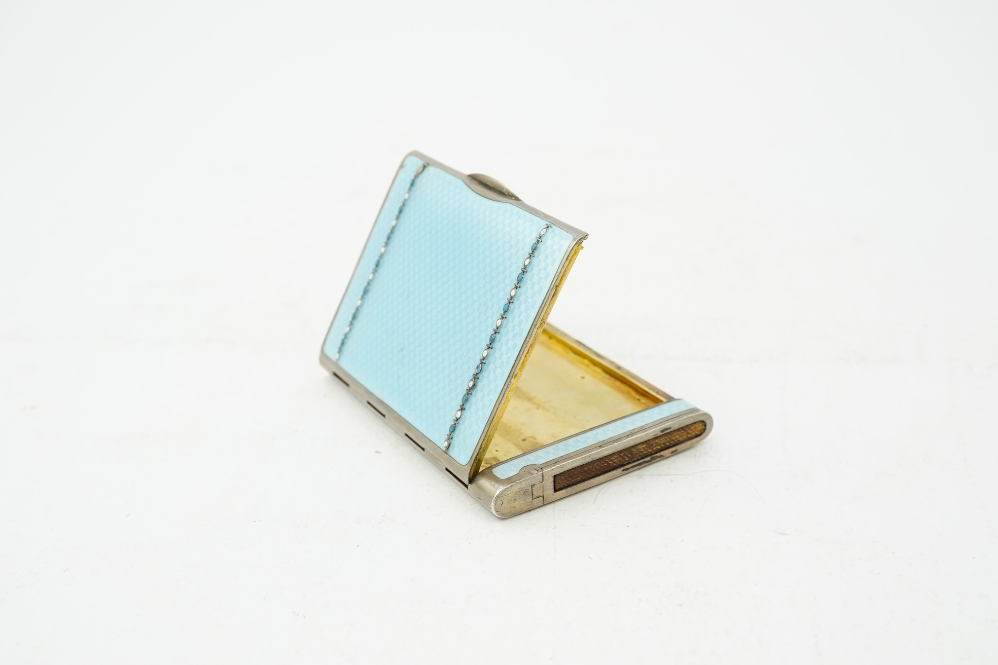An early 20th century Viennese sterling and blue enamel combination cigarette/vesta case, inscribed Carl Heiss Wien Graben 11